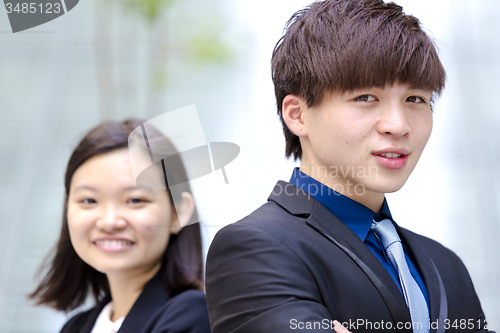 Image of Young Asian female and male business executive smiling portrait