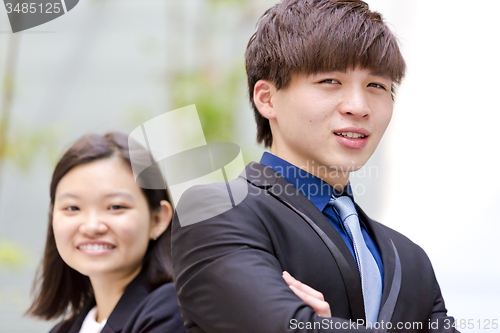 Image of Young Asian female and male business executive smiling portrait