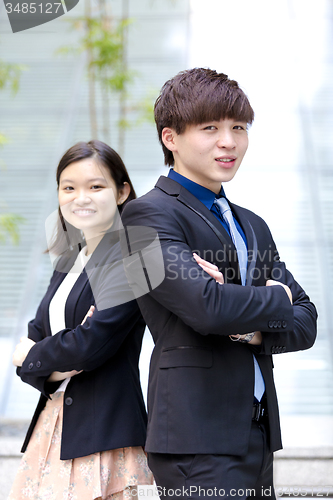 Image of Young Asian female and male business executive smiling portrait