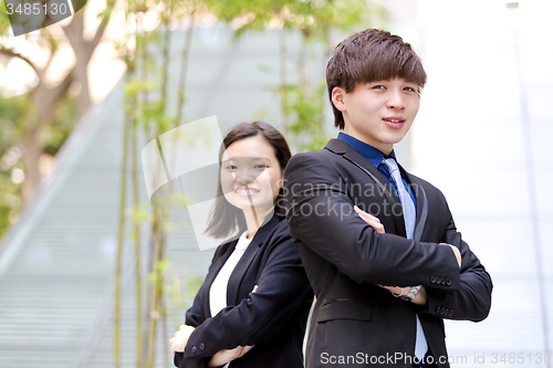 Image of Young Asian female and male business executive smiling portrait