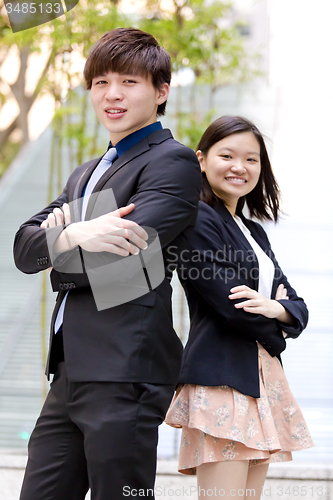 Image of Young Asian female and male business executive smiling portrait