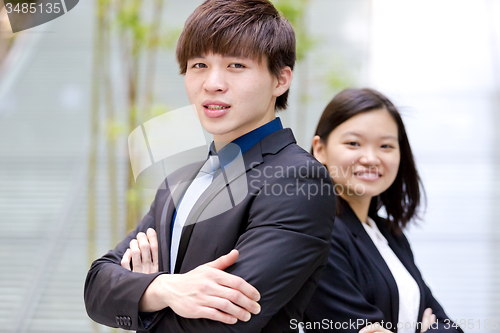 Image of Young Asian female and male business executive smiling portrait