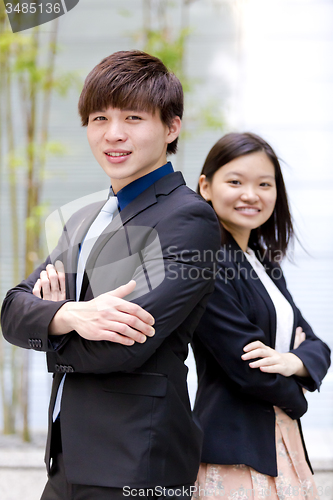 Image of Young Asian female and male business executive smiling portrait