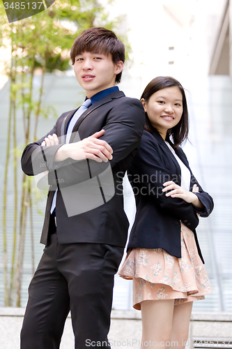 Image of Young Asian female and male business executive smiling portrait