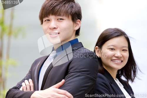 Image of Young Asian female and male business executive smiling portrait