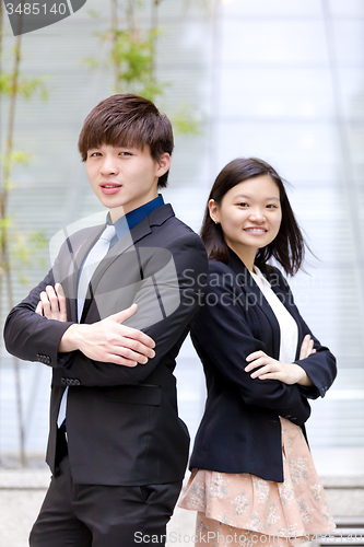 Image of Young Asian female and male business executive smiling portrait