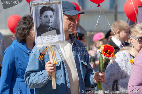 Image of Man hold a hero portrait