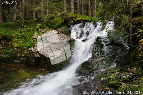 Image of waterfall in deep forest at mountains