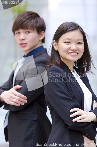 Image of Young Asian female and male business executive smiling portrait