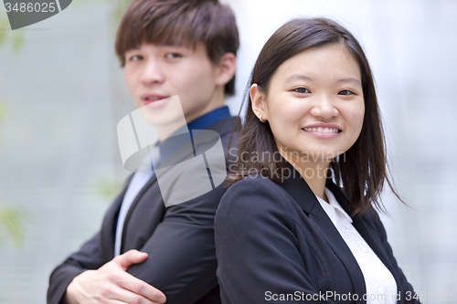 Image of Young Asian female and male business executive smiling portrait