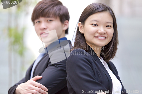 Image of Young Asian female and male business executive smiling portrait