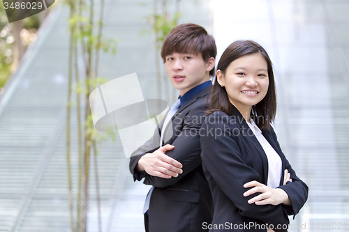 Image of Young Asian female and male business executive smiling portrait