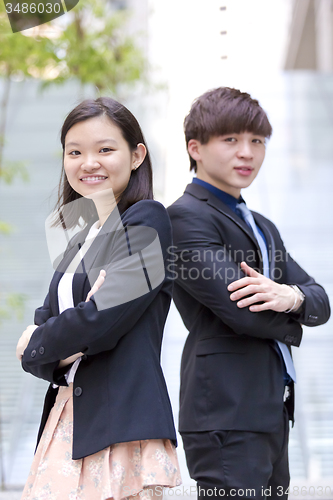 Image of Young Asian female and male business executive smiling portrait