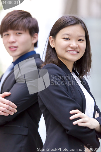 Image of Young Asian female and male business executive smiling portrait