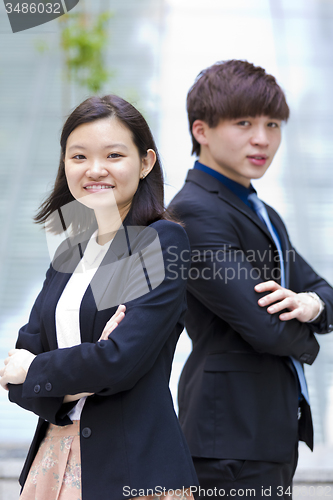 Image of Young Asian female and male business executive smiling portrait