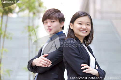 Image of Young Asian female and male business executive smiling portrait