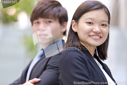 Image of Young Asian female and male business executive smiling portrait