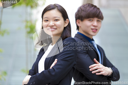 Image of Young Asian female and male business executive smiling portrait