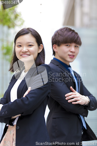 Image of Young Asian female and male business executive smiling portrait