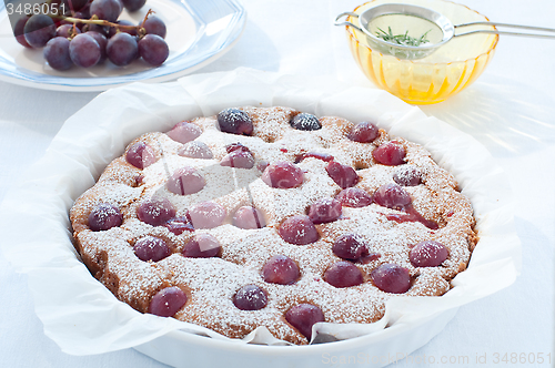 Image of Fresh cake with red grape season and icing sugar