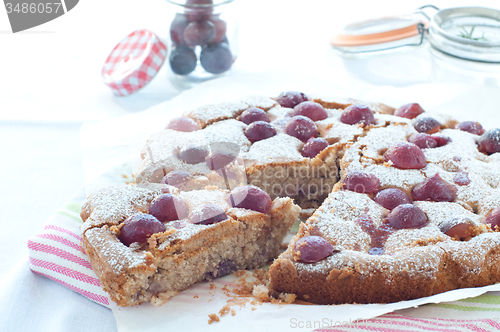 Image of Fresh cake with red grape season and icing sugar