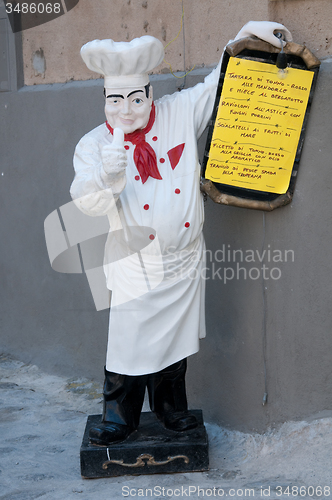 Image of Statue of chef holding a menu of a restaurant