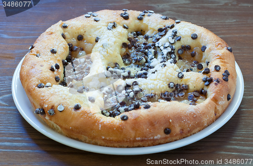 Image of Sweet cake with chocolate chunks, cheese and powdered sugar