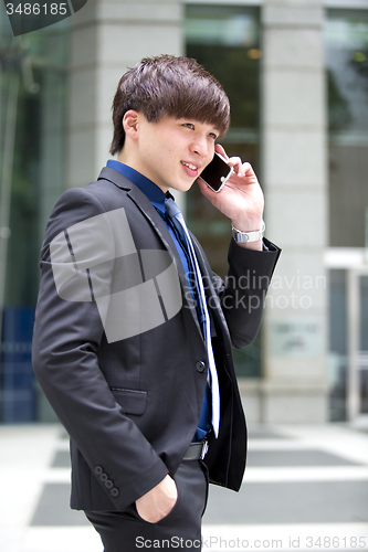 Image of Young Asian male business executive using smart phone