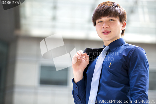 Image of Young Asian business executive in suit smiling portrait