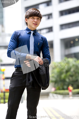 Image of Young Asian business executive in suit smiling portrait