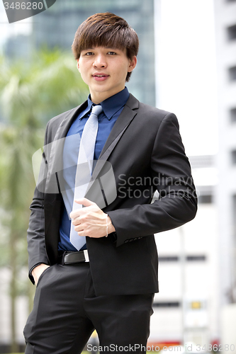Image of Young Asian business executive in suit smiling portrait