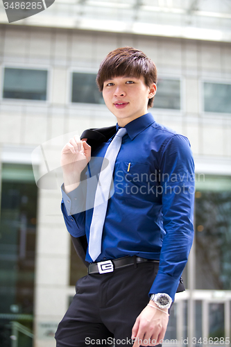 Image of Young Asian business executive in suit smiling portrait