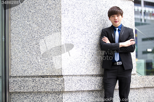 Image of Young Asian business executive in suit smiling portrait