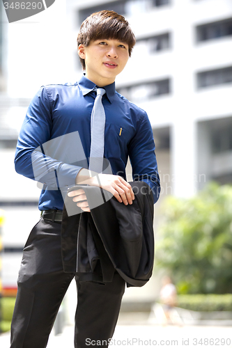 Image of Young Asian business executive in suit smiling portrait