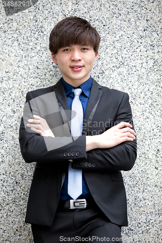 Image of Young Asian business executive in suit smiling portrait