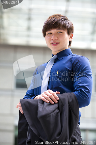 Image of Young Asian business executive in suit smiling portrait