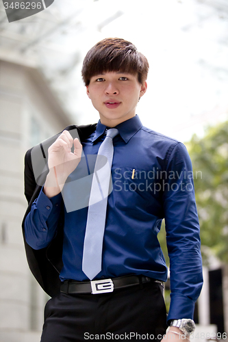 Image of Young Asian business executive in suit smiling portrait