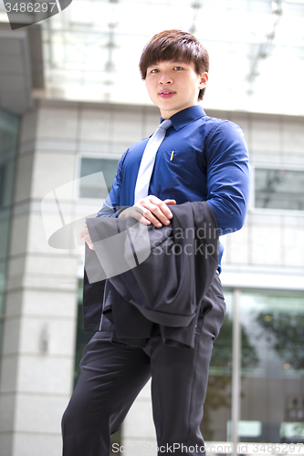 Image of Young Asian business executive in suit smiling portrait