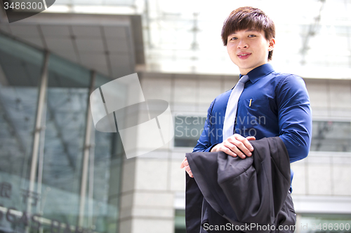 Image of Young Asian business executive in suit smiling portrait