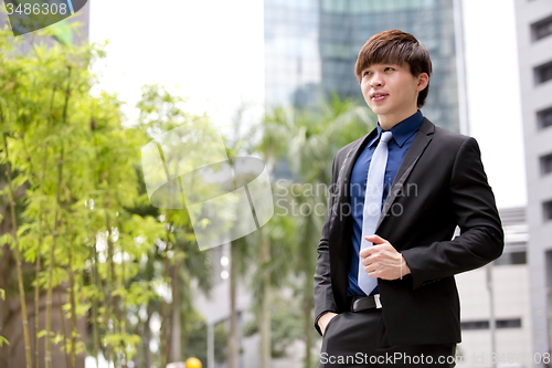 Image of Young Asian business executive in suit smiling portrait