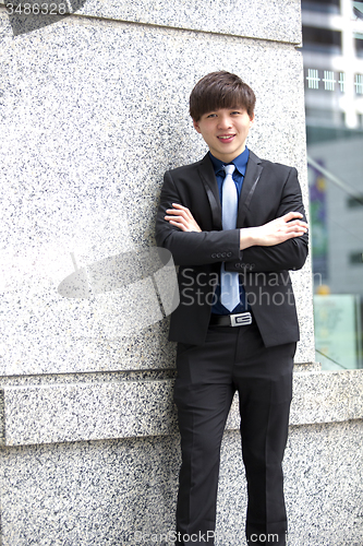 Image of Young Asian business executive in suit smiling portrait