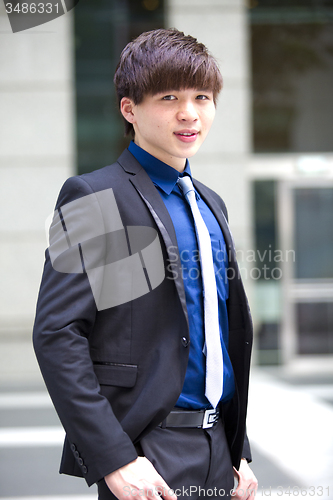 Image of Young Asian business executive in suit smiling portrait