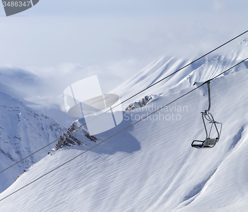 Image of Chair lift and mountains in fog