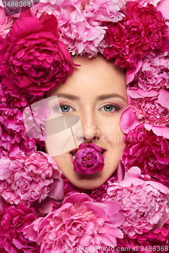 Image of Woman face in peony flowers