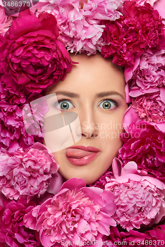 Image of Woman face in peony flowers