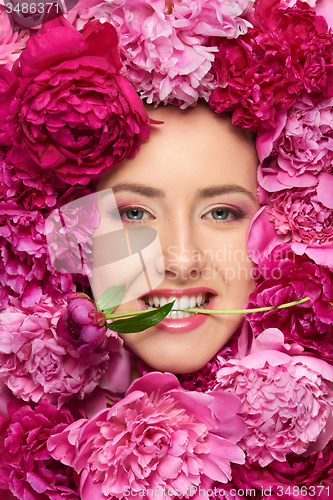 Image of Woman face in peony flowers