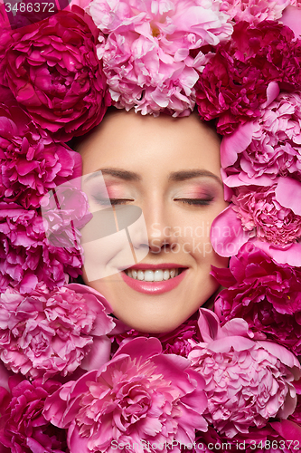 Image of Woman face in peony flowers
