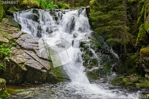 Image of waterfall in deep forest at mountains