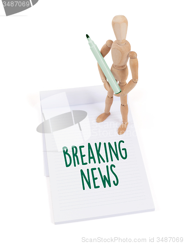 Image of Wooden mannequin writing - Breaking news