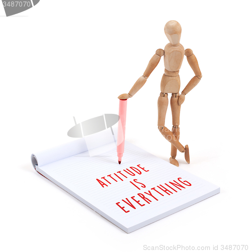 Image of Wooden mannequin writing - Attitude is everything